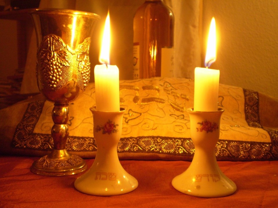 Shabbat candles, kiddush cup, and challah